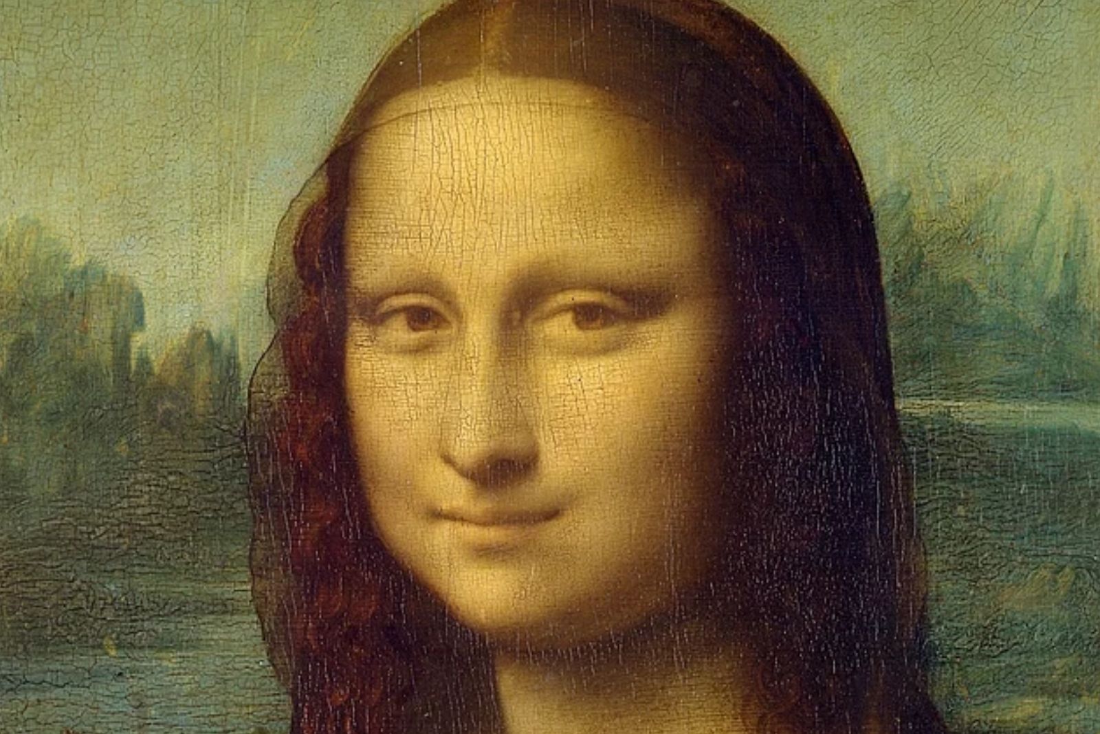 Close crop of the Mona Lisa's face and shoulders, showing the fine cracks in the paint surface and the hazy blue-green landscape behind her
