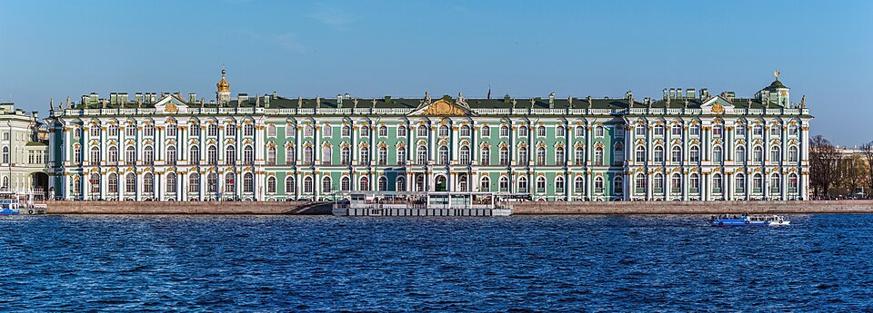The Winter Palace in St. Petersburg seen from the outside, its long green and white facade running along the square